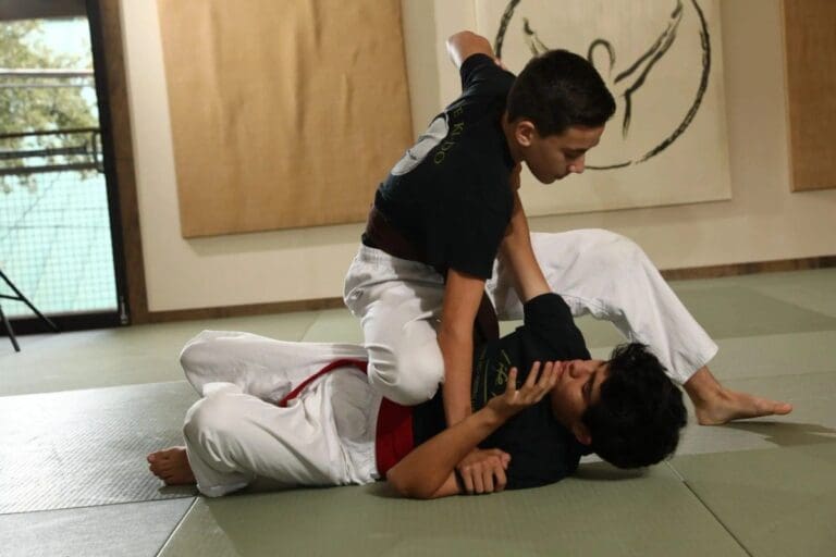 Teen students practicing Brazilian jiu-jitsu grappling and guard transition drill