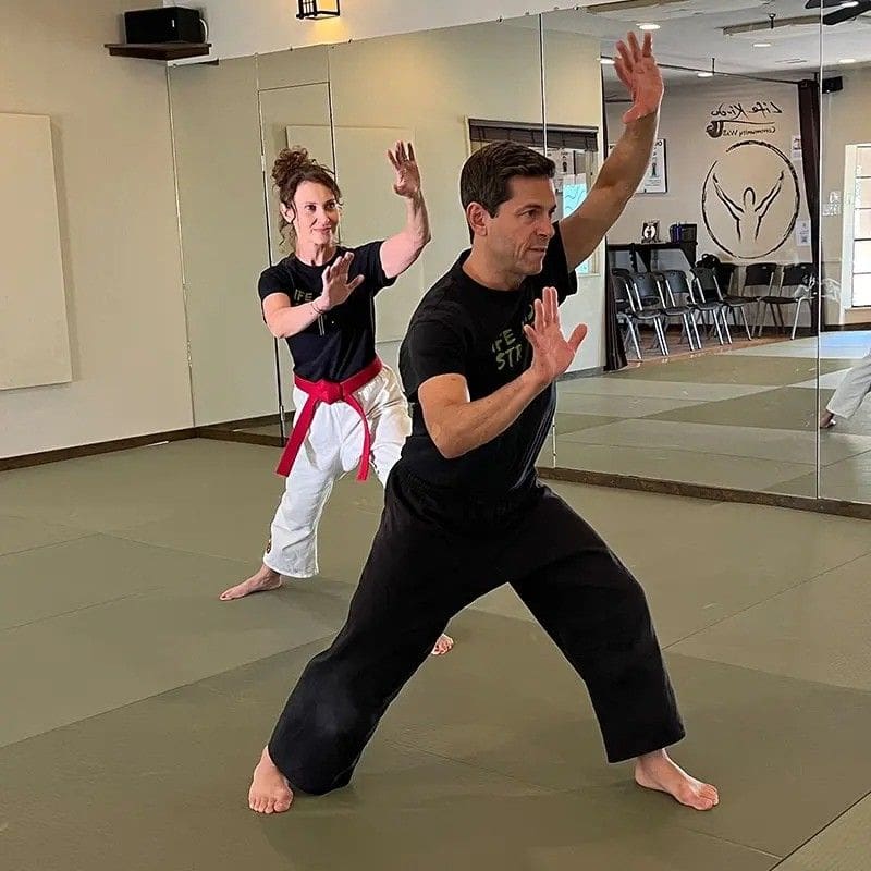 adults in a brazilian jiu jitsu stance