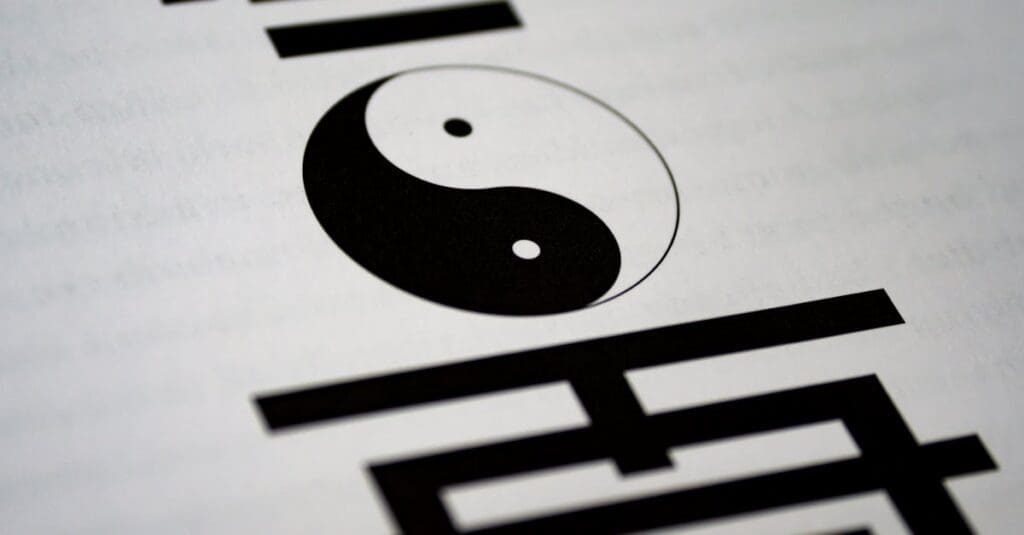 A close-up view of a printed Yin and Yang symbol on a page, representing the foundational philosophy behind Tai Chi for Beginners.