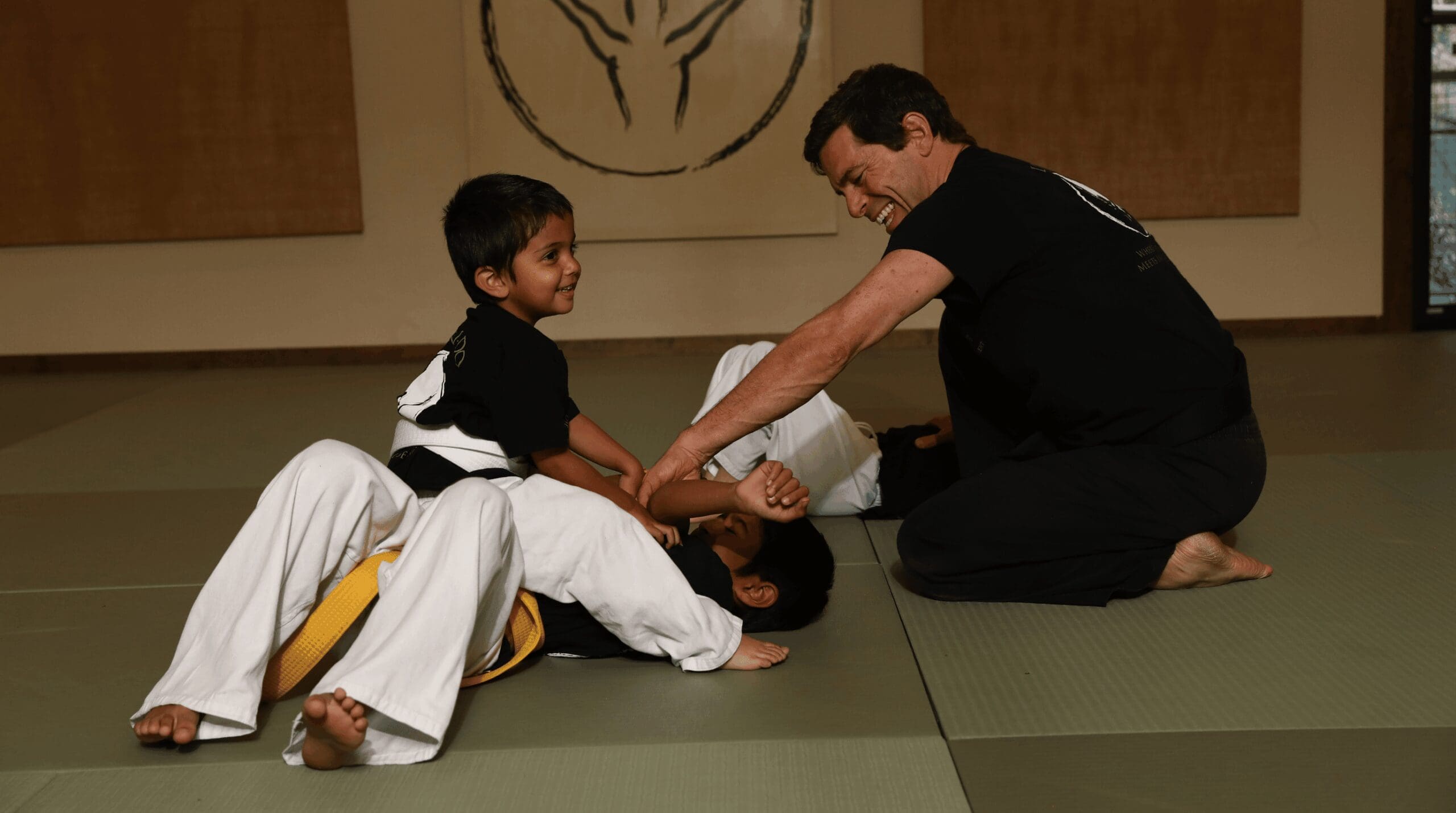 Martial arts instructor creating a positive and encouraging learning environment for young students during class.