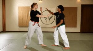 Teen girls practicing martial arts together in a supportive dojo
